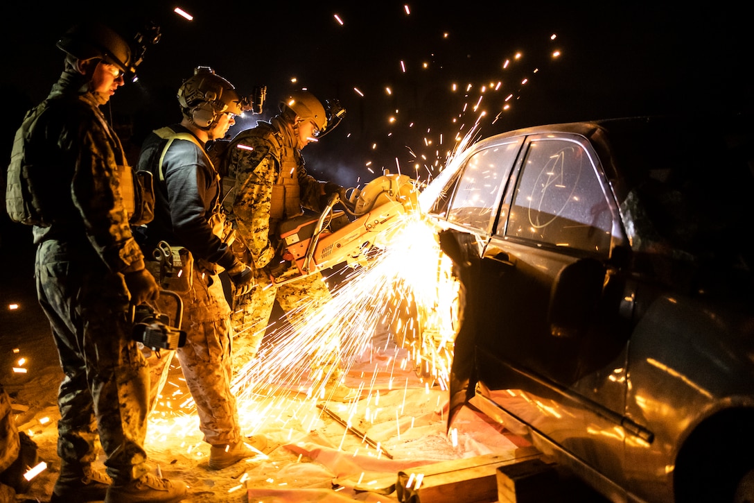 U.S. Marines with Marine Wing Support Squadron (MWSS) 372 cut into a staged vehicle during a tactical recovery of aircraft and personnel course hosted by the Amphibious Raids Branch, Expeditionary Operations Training Group, I Marine Expeditionary Force, at Marine Corps Base Camp Pendleton, California, May 15, 2025.