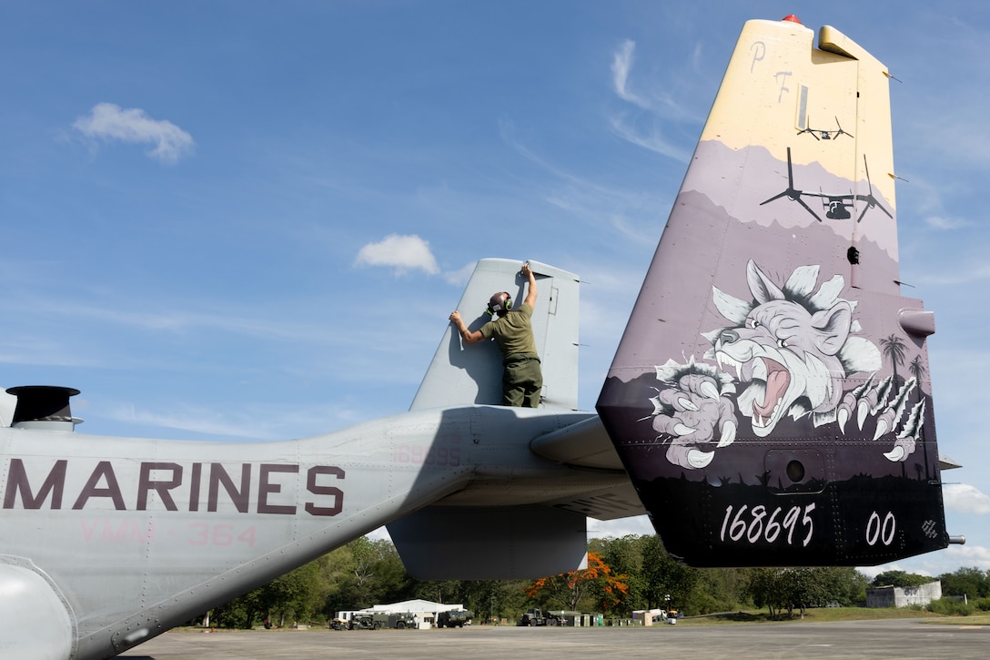 U.S. Marine Corps Lance Cpl. Justin Gonzales, an MV-22B Osprey flight line mechanic with Marine Medium Tiltrotor Squadron (VMM) 364, Marine Aircraft Group 39, 3rd Marine Aircraft Wing, inspects a U.S. Marine Corps MV-22B Osprey assigned to VMM-364 during KAMANDAG 9 at Clark Air Base, Angeles, Philippines, May 26, 2025.