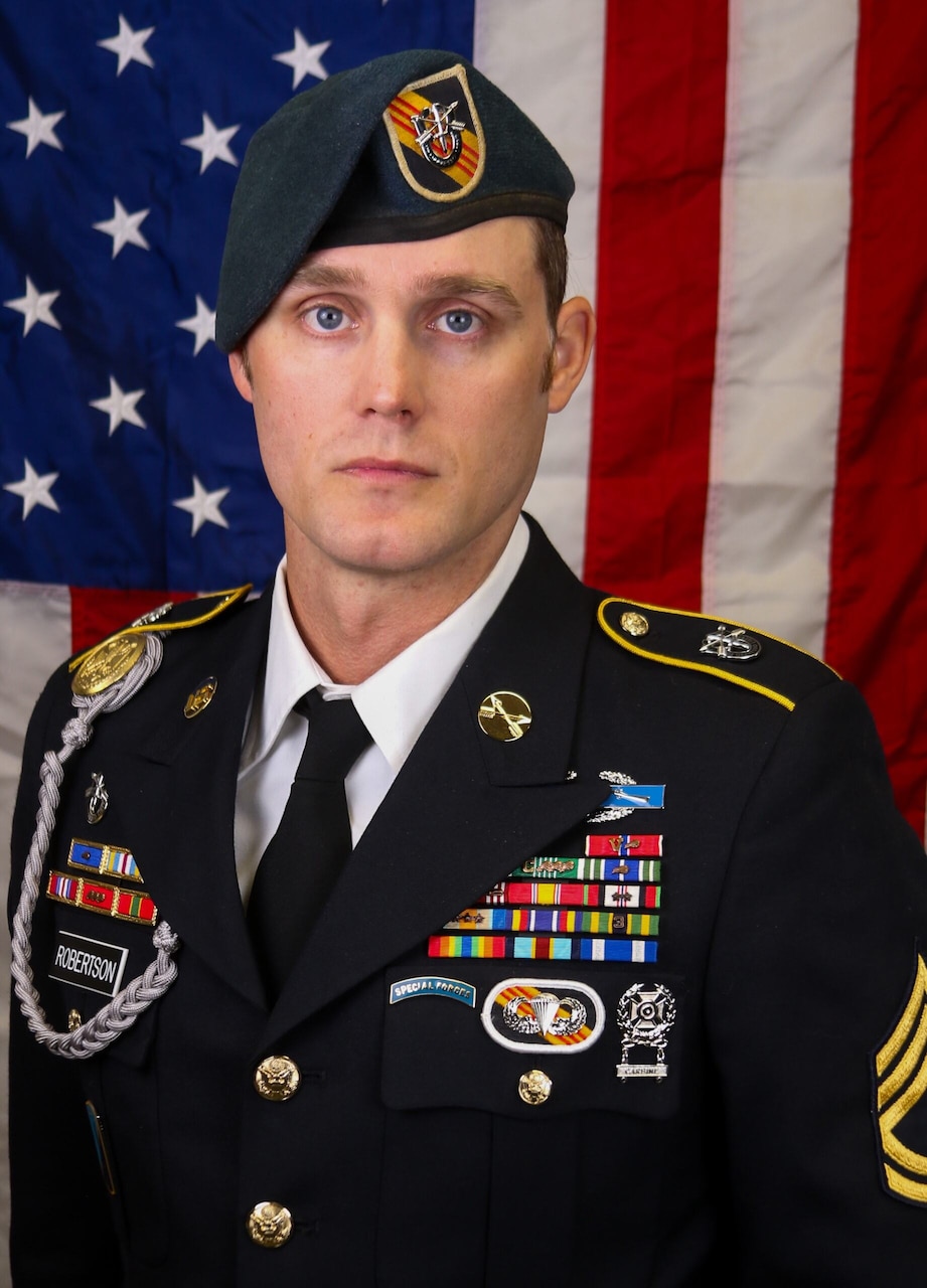 A man in uniform poses for a photo.