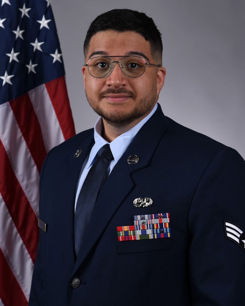 A man in uniform poses for a photo.