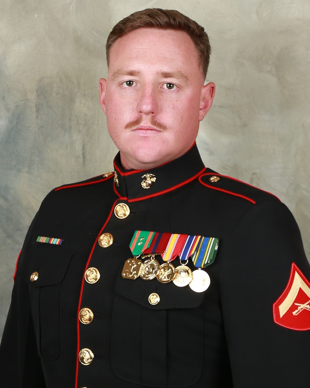 A man in uniform poses for a photo.