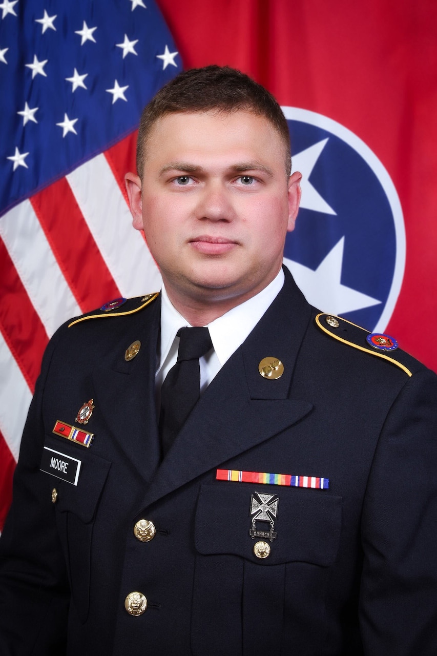 A man in uniform poses for a photo.