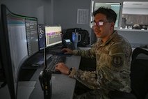 An Airman sits at a computer