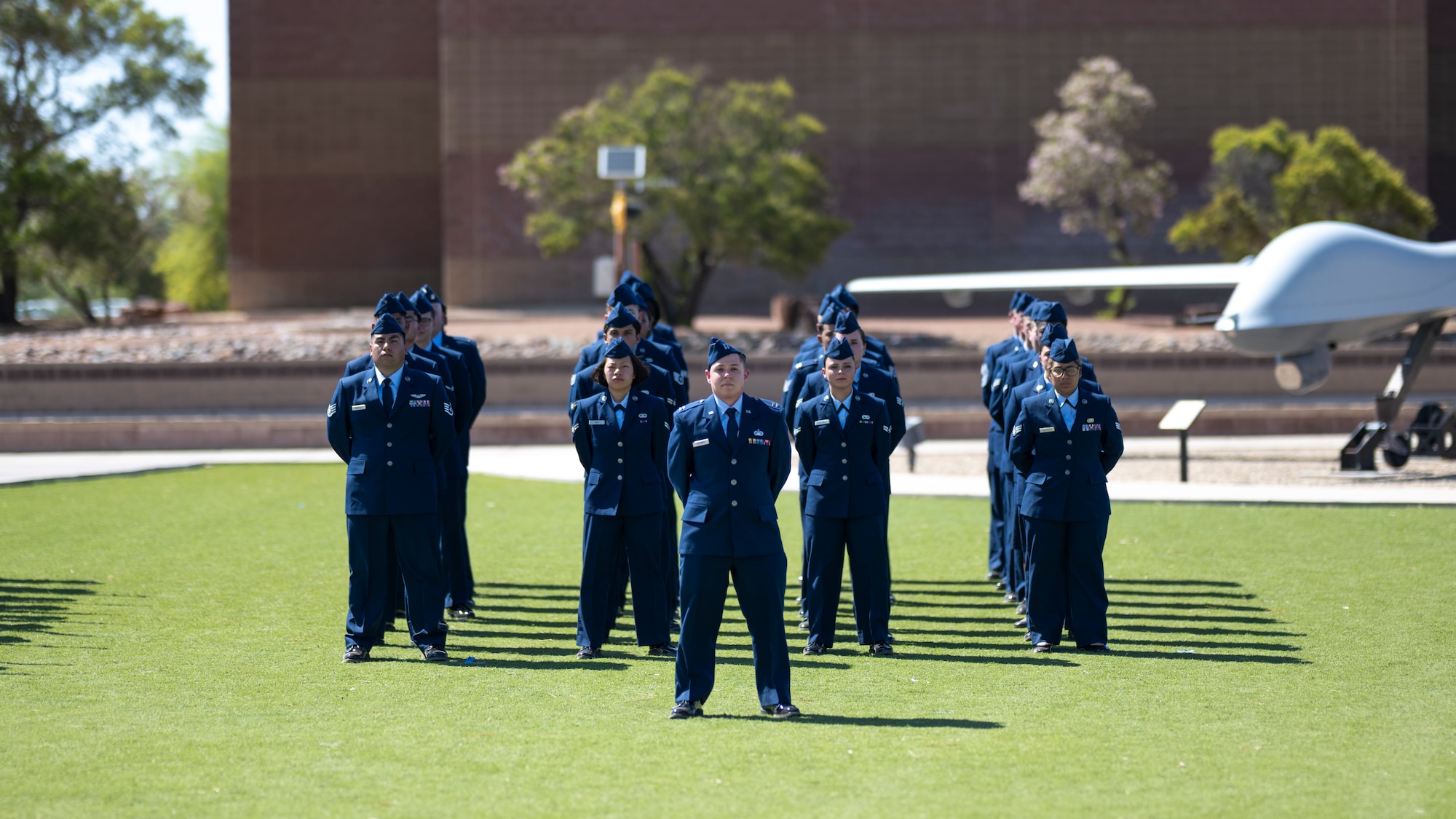 Team Holloman Airmen stand at parade rest during a Memorial Day ceremony at Holloman Air Force Base, New Mexico, May 22, 2025. Memorial Day originated as Decoration Day in the years following the Civil War, where the graves of fallen service members were adorned with flowers, and after gaining prominence over time, the tradition was officially established as a national holiday on the final Monday of May by Congress in 1968. (U.S. Air Force photo by Tech. Sgt. Victor J. Caputo)
