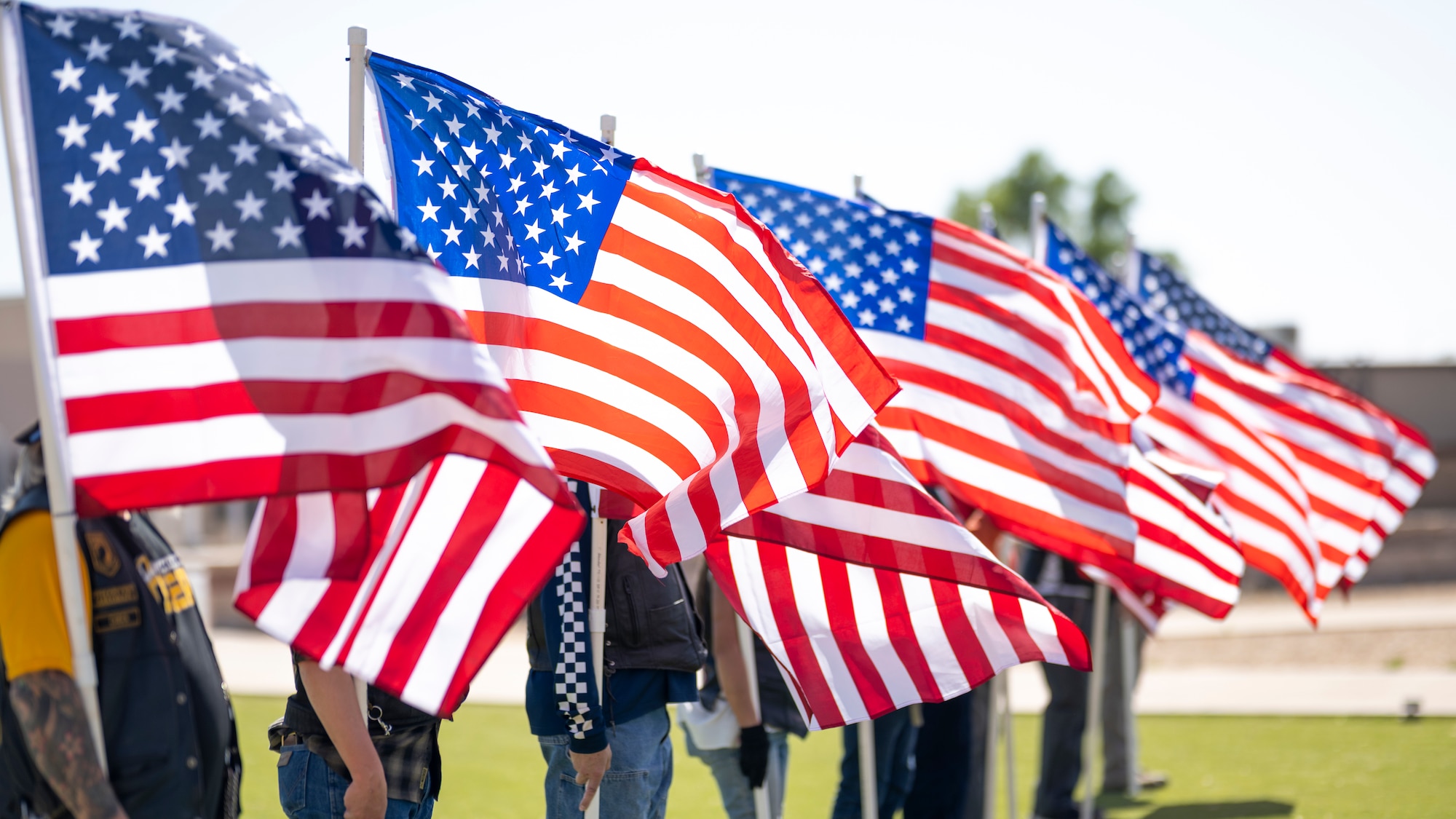 Patriot Guard Riders stand at attention with the American Flag during a Memorial Day ceremony at Holloman Air Force Base, New Mexico, May 22, 2025. More than 30 family members of fallen service members attended the ceremony alongside the Team Holloman community to honor the sacrifice of their sons and daughters, husbands and wives, and brothers and sisters. (U.S. Air Force photo by Tech. Sgt. Victor J. Caputo)