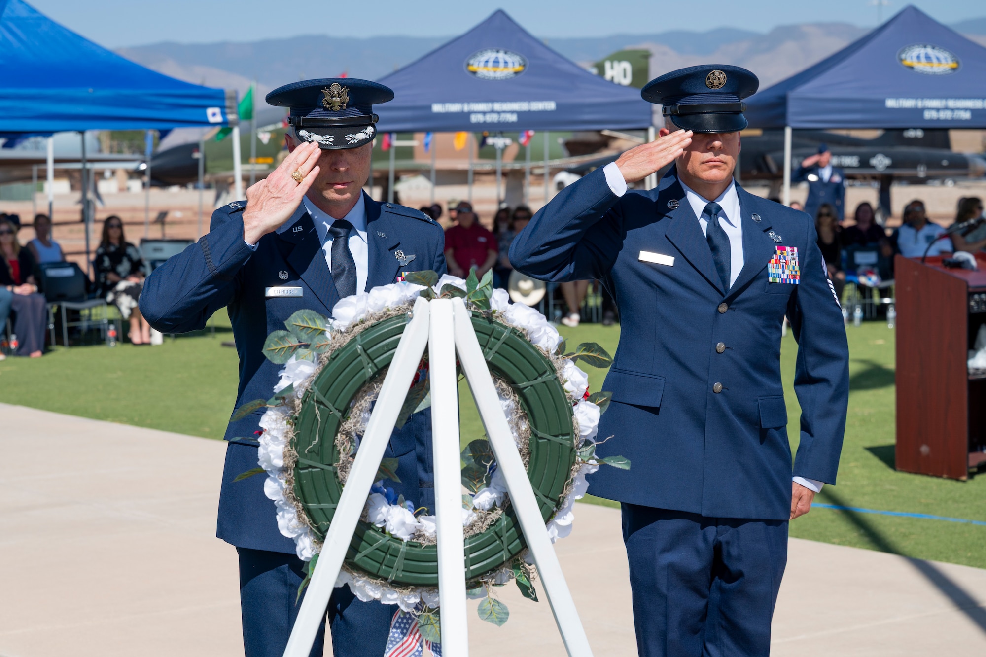 U.S. Air Force Col. John Ethridge and U.S. Air Force Chief Master Sgt. William Ford, 49th Wing commander and command chief, respectively, salute a wreath during a Memorial Day ceremony at Holloman Air Force Base, New Mexico, May 22, 2025. The 49th Wing hosts an annual Memorial Day ceremony to unite the Team Holloman community in honoring all U.S. service members who made the ultimate sacrifice in defense and support of the nation. (U.S. Air Force photo by Tech. Sgt. Victor J. Caputo)