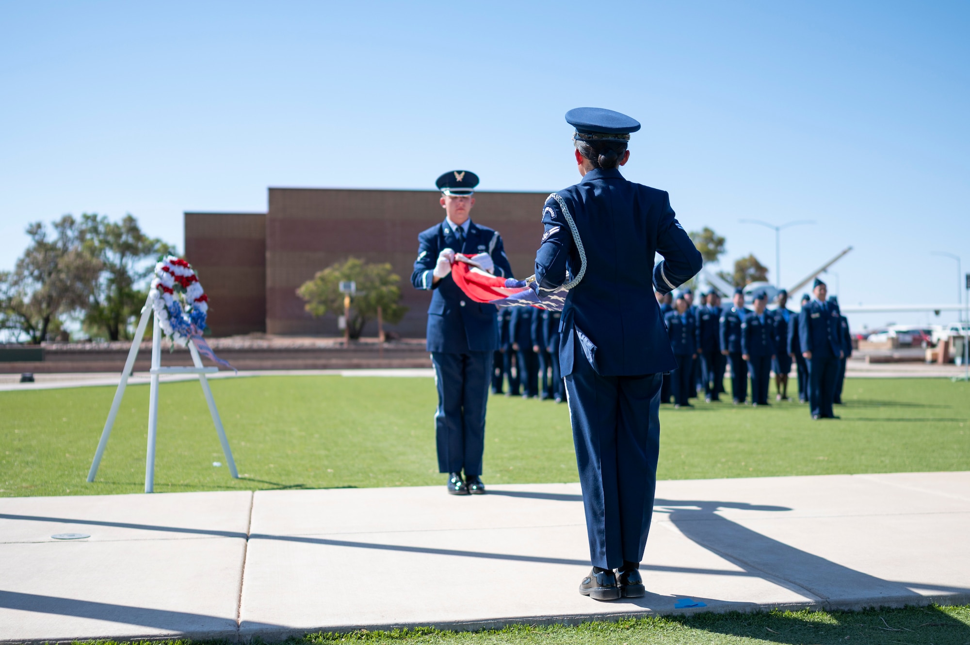 Members of the Steel Talons Honor Guard fold the American Flag during a Memorial Day ceremony at Holloman Air Force Base, New Mexico, May 22, 2025. The 49th Wing hosts an annual Memorial Day ceremony to unite the Team Holloman community in honoring all U.S. service members who made the ultimate sacrifice in defense and support of the nation.(U.S. Air Force photo by Tech. Sgt. Victor J. Caputo)