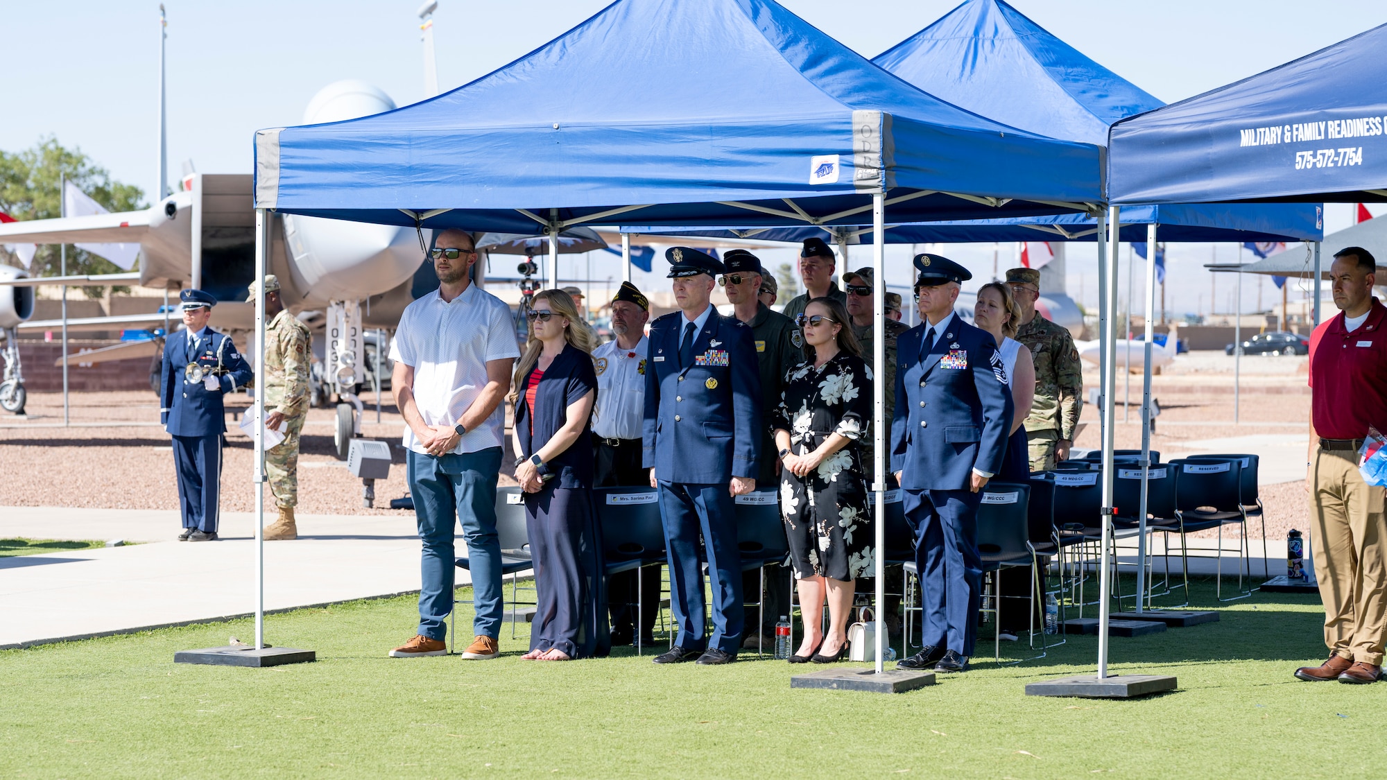Team Holloman members and local and state officials watch as the base honor guard conducts a flag fold during a Memorial Day ceremony at Holloman Air Force Base, New Mexico, May 22, 2025. More than 30 family members of fallen service members attended the ceremony alongside the Team Holloman community to honor the sacrifice of their sons and daughters, husbands and wives, and brothers and sisters. (U.S. Air Force photo by Tech. Sgt. Victor J. Caputo)