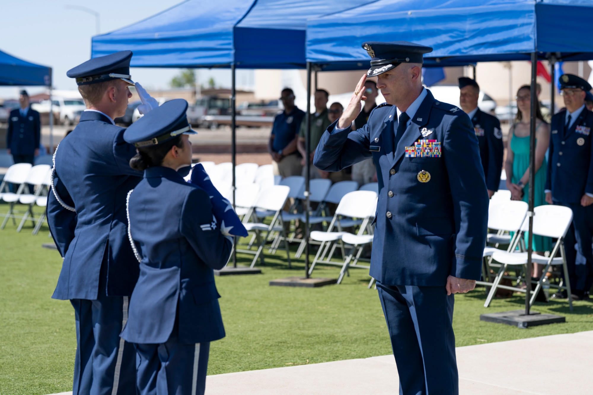 Members of the Steel Talons Honor Guard present the installation flag to U.S. Air Force Col. John Ethridge, 49th Wing commander, during a Memorial Day ceremony at Holloman Air Force Base, New Mexico, May 22, 2025. The 49th Wing hosts an annual Memorial Day ceremony to unite the Team Holloman community in honoring all U.S. service members who made the ultimate sacrifice in defense and support of the nation. (U.S. Air Force photo by Tech. Sgt. Victor J. Caputo)