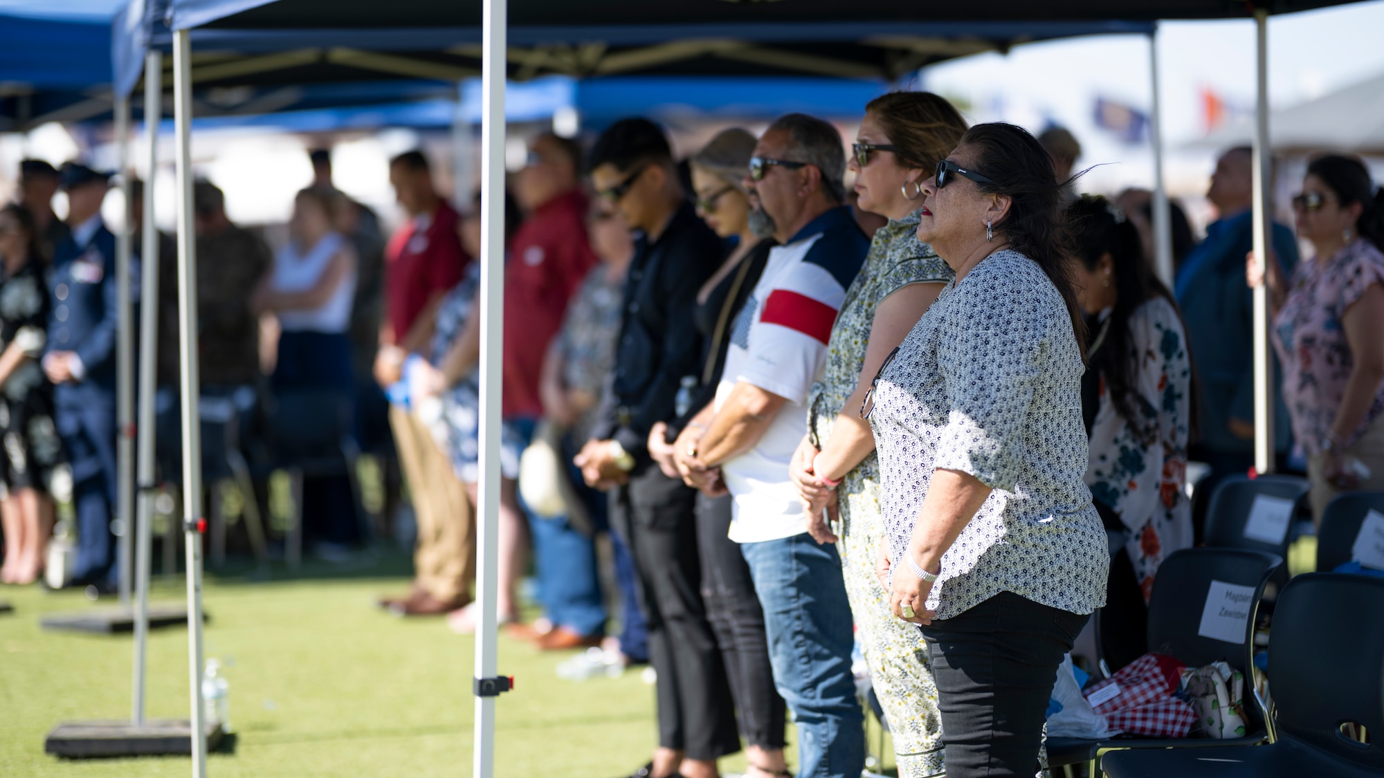 Gold Star Family and Air Force Families Forever members watch a Memorial Day ceremony at Holloman Air Force Base, New Mexico, May 22, 2025. More than 30 family members of fallen service members attended the ceremony alongside the Team Holloman community to honor the sacrifice of their sons and daughters, husbands and wives, and brothers and sisters. (U.S. Air Force photo by Tech. Sgt. Victor J. Caputo)