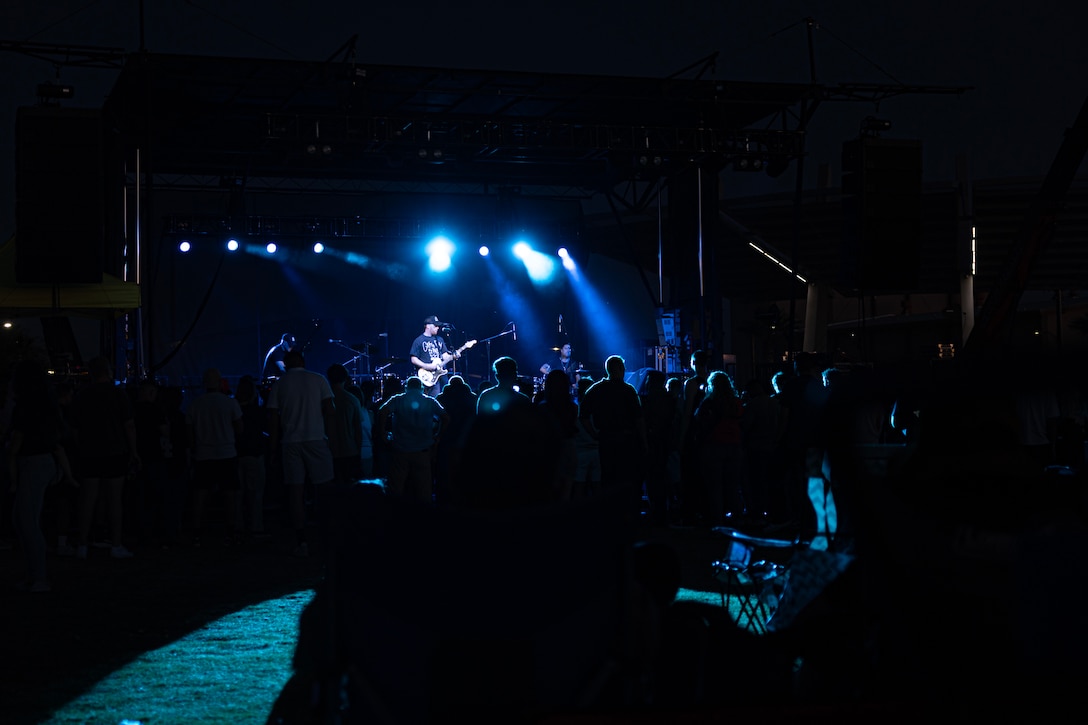 Sam Tinnesz performs during the 250th We Salute You Bash at Victory Field, Marine Corps Air Ground Combat Center, Twentynine Palms, California, May 9, 2025. The Combat Center hosts this event annually to thank service members and their families for their dedication and sacrifice. (U.S. Marine Corps Photo by Lance Cpl. Enge You)