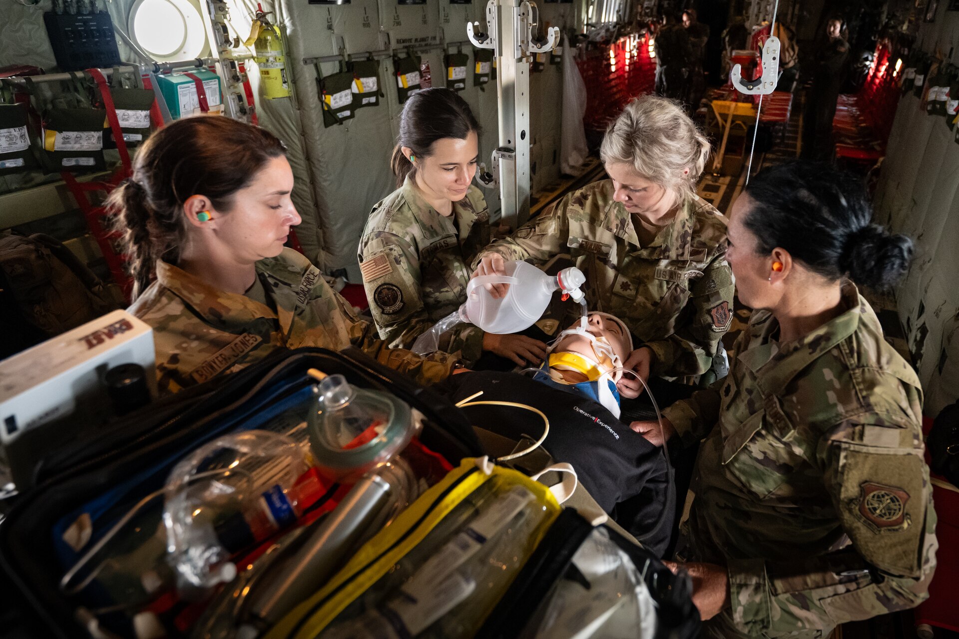 Airmen from a 123rd Medical Group Critical Care Air Transport Team stabilize a simulated patient May 14, 2025, during a flight from Murray to Paducah, Ky., aboard a Kentucky Air National Guard C-130J Super Hercules aircraft.