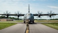 An airman from the 123rd Contingency Response Group marshals a C-130J Super Hercules from the Kentucky Air National Guard down a taxiway at Murray-Calloway County Airport in Murray, Ky., May 14, 2025, as part of Exercise Grindstone, a major earthquake-response simulation.