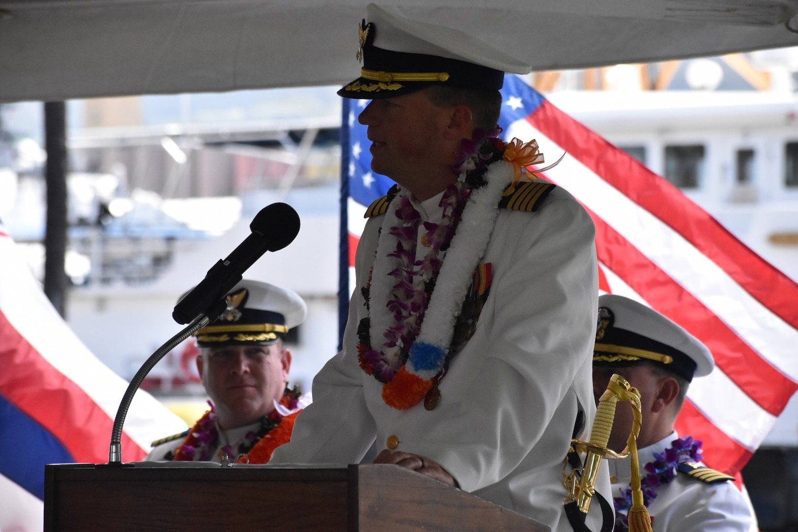 Capt. Matthew Rooney, commanding officer of U.S. Coast Guard Cutter Midgett (WMSL 757) delivers remarks during the change of command ceremony for Midgett in Honolulu, May 23, 2025. Commissioned in 2019, Midgett is named after the Midgett family and is one of two Coast Guard legend-class National Security Cutters homeported in Honolulu. (U.S. Coast Guard photo by Ens. Harlan Brady).