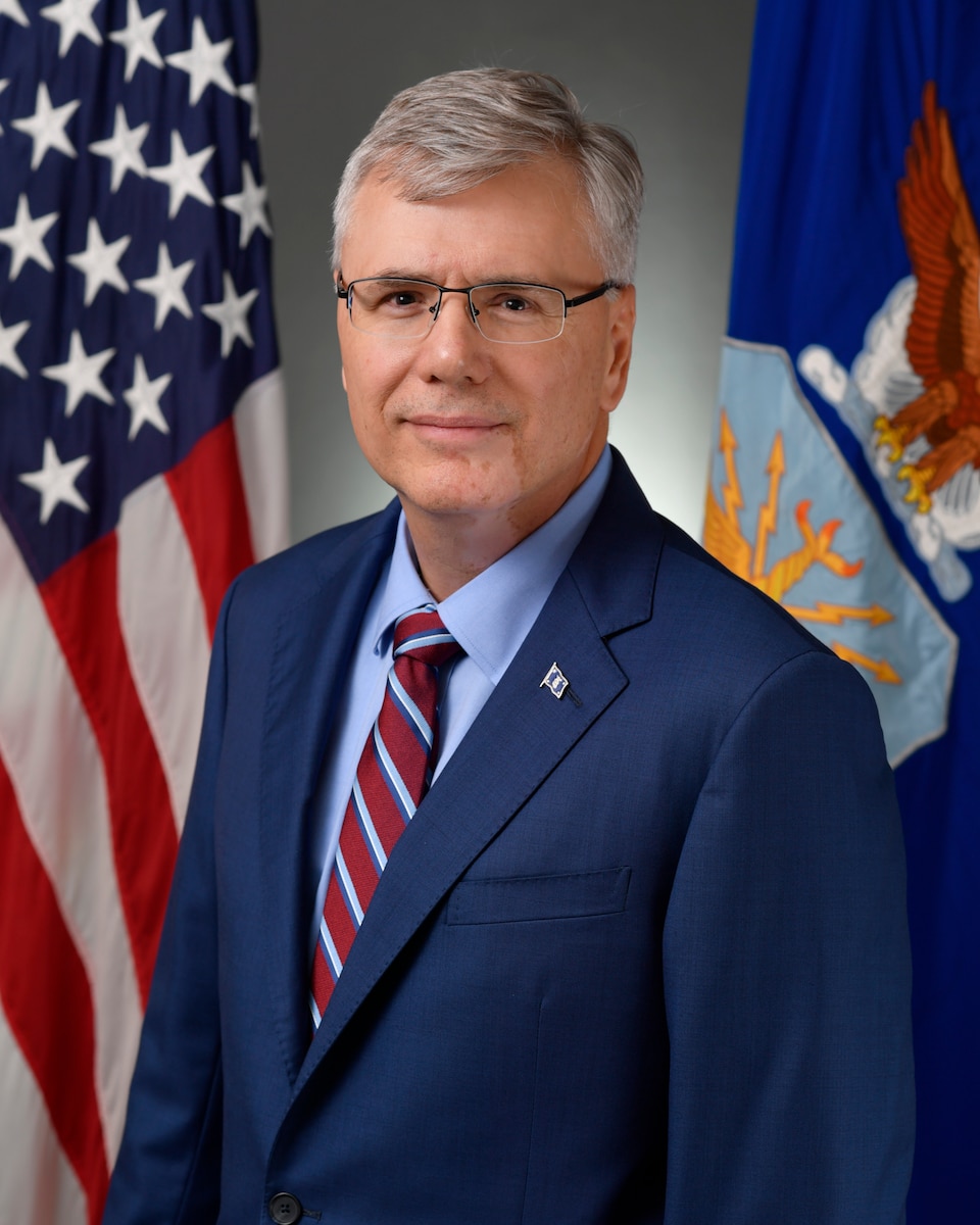 A man in a suit posing for a photo