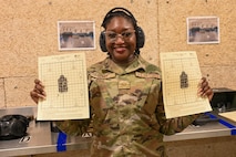 U.S. Air Force Senior Airman Dominique Henry, contracting specialist assigned to the 5th contracting squadron, poses with her score sheet at Minot Air Force Base, May 8, 2025. Henry posed after receiving a passing grade for her shooting at Combat Arms Training and Maintenance training course.(U.S. Air Force photo by Airman 1st Class Anthony Ramey)