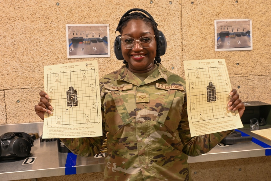 U.S. Air Force Senior Airman Dominique Henry, contracting specialist assigned to the 5th contracting squadron, poses with her score sheet at Minot Air Force Base, May 8, 2025. Henry posed after receiving a passing grade for her shooting at Combat Arms Training and Maintenance training course.(U.S. Air Force photo by Airman 1st Class Anthony Ramey)