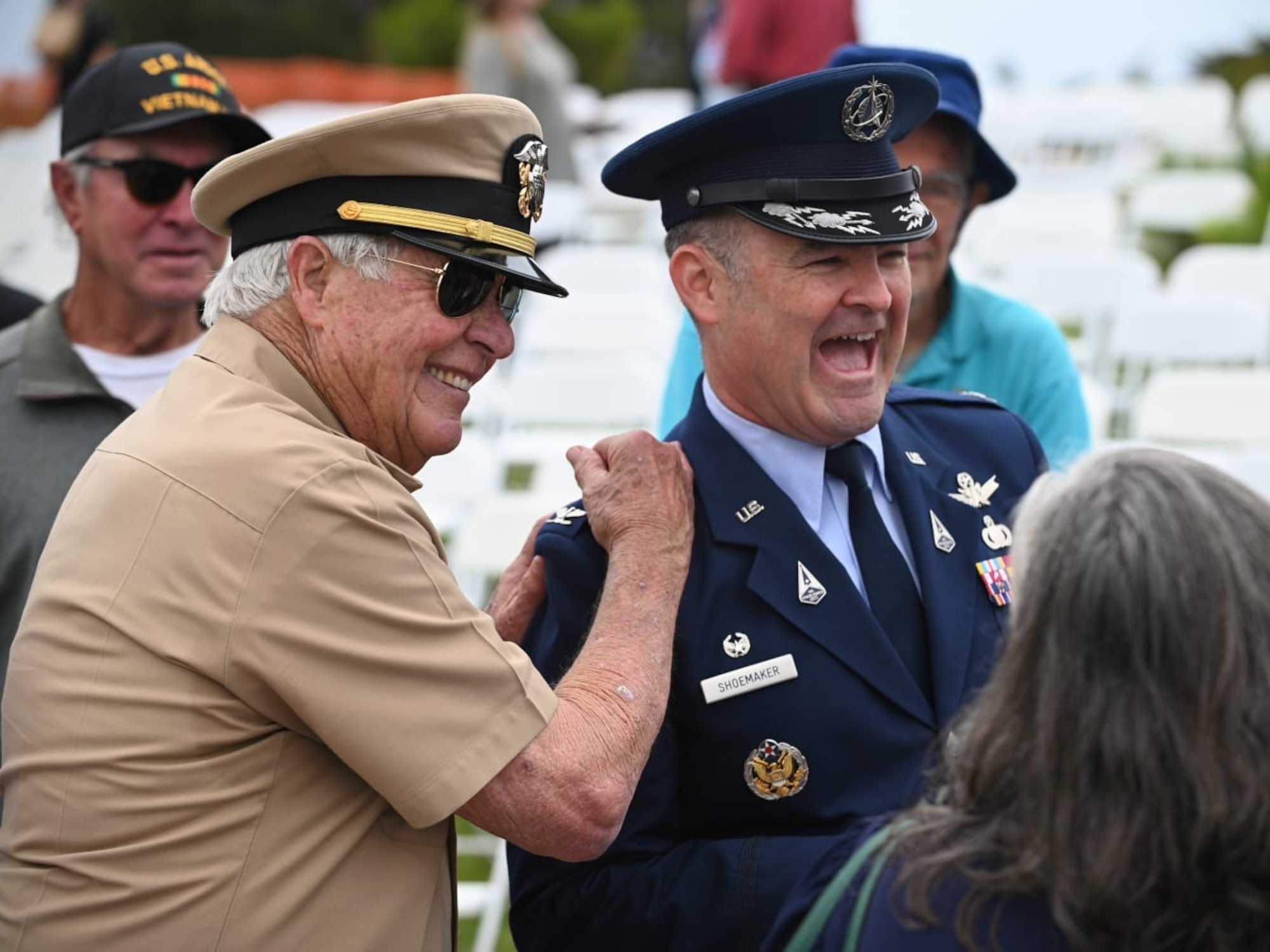 U.S. Navy Lieutenant John Blankenship (ret.), and United States Space Force Col. Mark Shoemaker, Space Launch Delta 30 commander, share a moment of friendly jests during the annual Memorial Day Ceremony held at the Santa Barbara Cemetery in Santa Barbara, Calif., May 26. 2025. All in attendance paid tribute to military members across the globe who made the ultimate sacrifice in service to the nation.