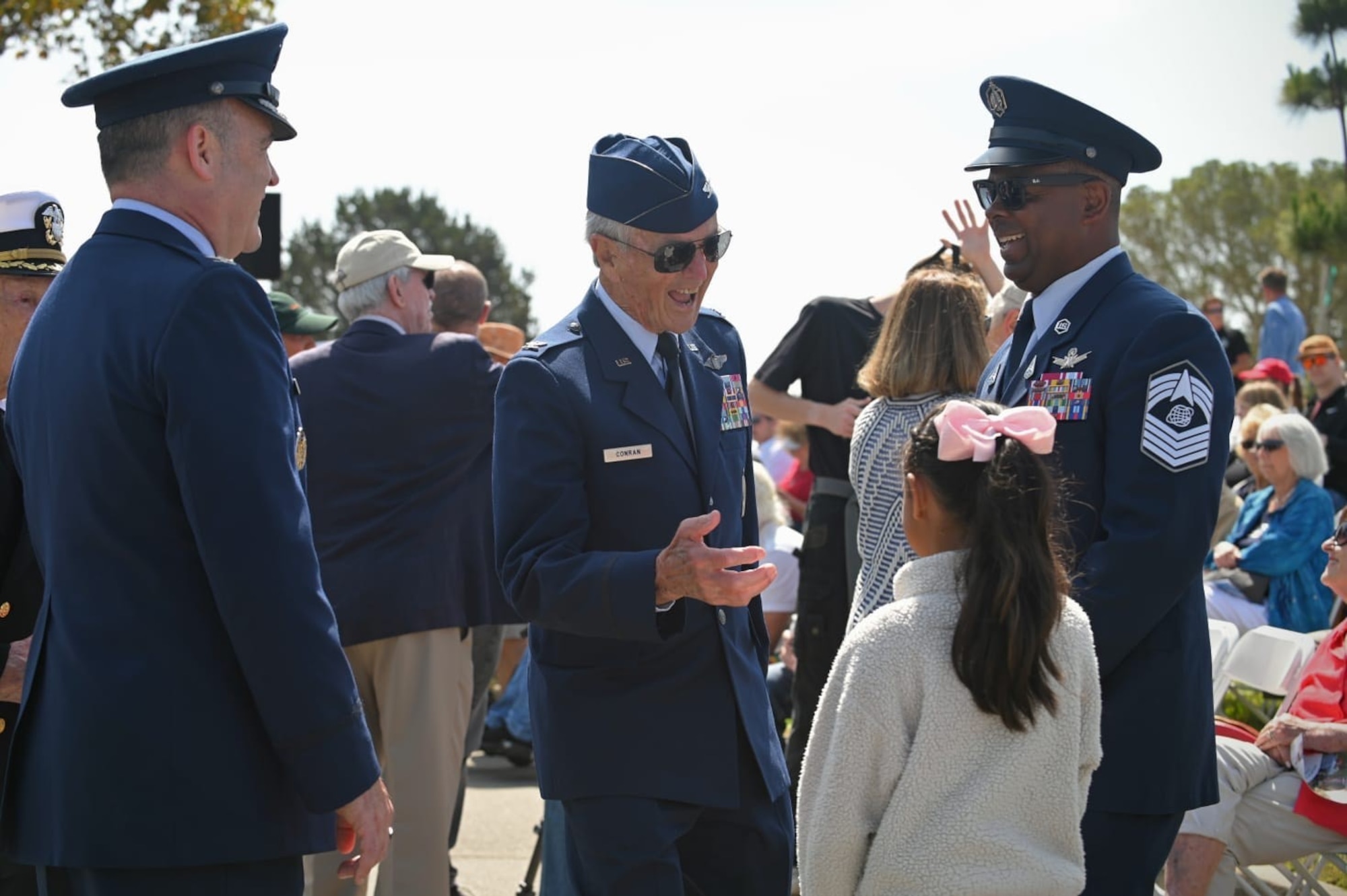U.S. Air Force Col. Phil Conran (ret.), center, shares military stories with U.S. Space Force Chief Master Sgt. Johnny Harris, Space Launch Delta 30 senior enlisted leader, right, his daughter, and U.S. Space Force Col. Mark Shoemaker, Space Launch Delta 30 commander, before a Memorial Day ceremony at the Santa Barbara Cemetery in Santa Barbara, Calif., May 26, 2025. (U.S. Space Force photo by Tech. Sgt. Draeke Layman)