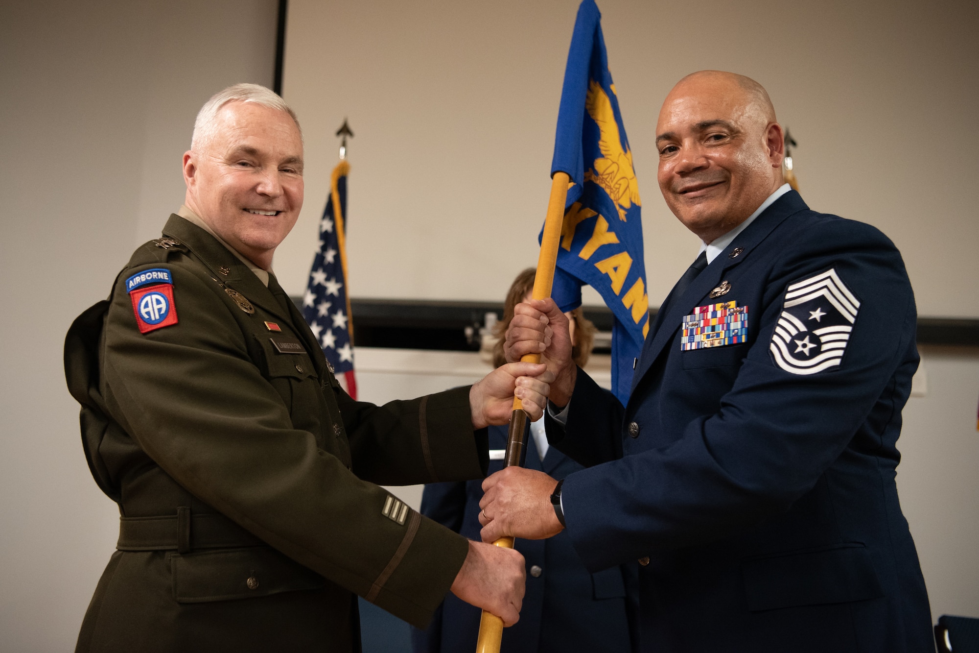 U.S. Air Force Chief Master Sgt. Steven Best, right, accepts the guidon for Joint Force Headquarters—Kentucky/Air from U.S. Army Maj. Gen. Haldane Lamberton, adjutant general of the Kentucky National Guard,  signifying Best’s assumption of the role of state command chief during a ceremony at the Kentucky Air National Guard Base in Louisville, Ky., April 13, 2025. Best replaces U.S. Air Force Chief Master Sgt. James Tongate, who is retiring. (U.S. Air National Guard photo by Master Sgt. Joshua Horton)