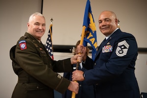 U.S. Air Force Chief Master Sgt. Steven Best, right, accepts the guidon for Joint Force Headquarters—Kentucky/Air from U.S. Army Maj. Gen. Haldane Lamberton, adjutant general of the Kentucky National Guard,  signifying Best’s assumption of the role of state command chief during a ceremony at the Kentucky Air National Guard Base in Louisville, Ky., April 13, 2025. Best replaces U.S. Air Force Chief Master Sgt. James Tongate, who is retiring. (U.S. Air National Guard photo by Master Sgt. Joshua Horton)