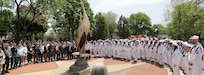 Local residents, veterans and service members gather at the eternal Flame at Memorial Park following the annual Memorial Day parade and ceremony in Arlington Heights, Illinois, May 26, 2025.