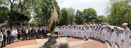 Local residents, veterans and service members gather at the eternal Flame at Memorial Park following the annual Memorial Day parade and ceremony in Arlington Heights, Illinois, May 26, 2025.