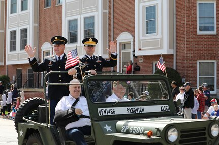 Retired Sgt. Maj. Dennis Koski, left, formerly assigned to the 85th U.S. Army Reserve Support Command, waves in a jeep during the Arlington Heights Memorial Day parade and ceremony, May 26, 2025.