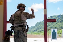 U.S. Air Force Staff Sgt. Kevin Santos, 673rd Security Forces Squadron military working dog handler assigned to Joint Base Elmendorf-Richardson, Alaska, gives a ready signal to participate in a simulated stress fire event during a Pacific Air Forces Advanced Combat Skills Assessment K9 competition at Andersen Air Force Base, Guam, May 22, 2025.