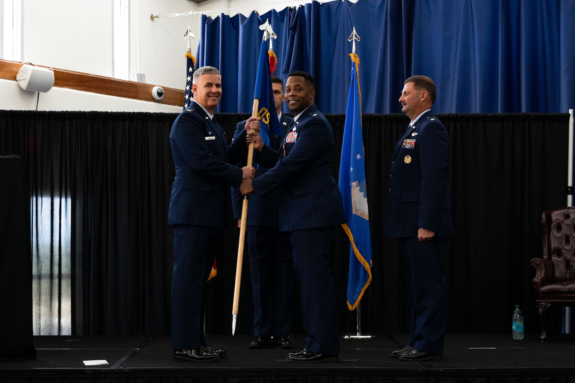 U.S. Air Force Lt. Col. Edwin Pratt, 36th Operations Support Squadron commander, relinquishes command during a change of command ceremony May 16, 2025, at Andersen Air Force Base, Guam. The passing of the guidon during the ceremony symbolizes the transfer of responsibilities from the outgoing commander to the incoming commander. (U.S. Air Force photo by Staff Sgt. Jasmine M. Barnes)