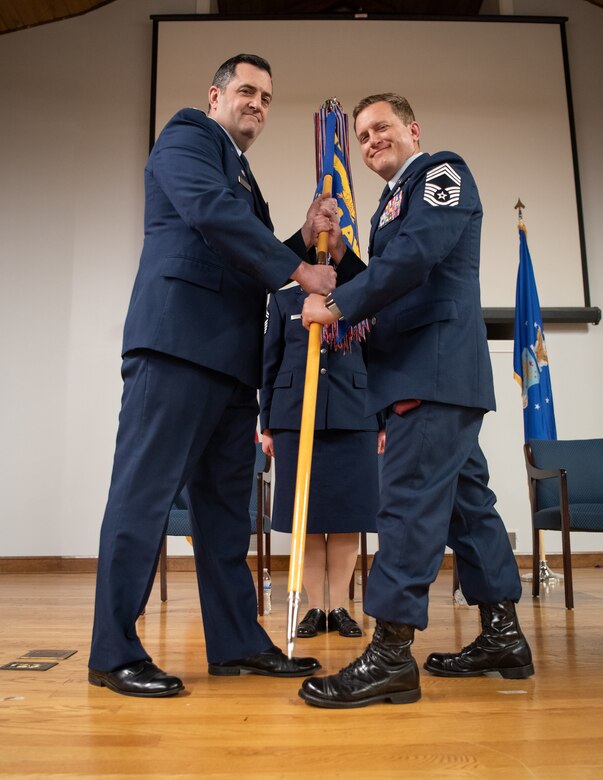 Chief Master Sgt. Blair Baerny, right, accepts the 123rd Airlift Wing guidon from Col. Matthew Quienichet, 123rd Airlift Wing commander, signifying Baerny’s assumption of the role of wing command chief during a ceremony at the Kentucky Air National Guard Base in Louisville, Ky., April 13, 2025. Baerny replaces Chief Master Sgt. Steven Best, who was named state command chief for the Kentucky Air National Guard. (U.S. Air National Guard photo by Master Sgt. Joshua Horton)