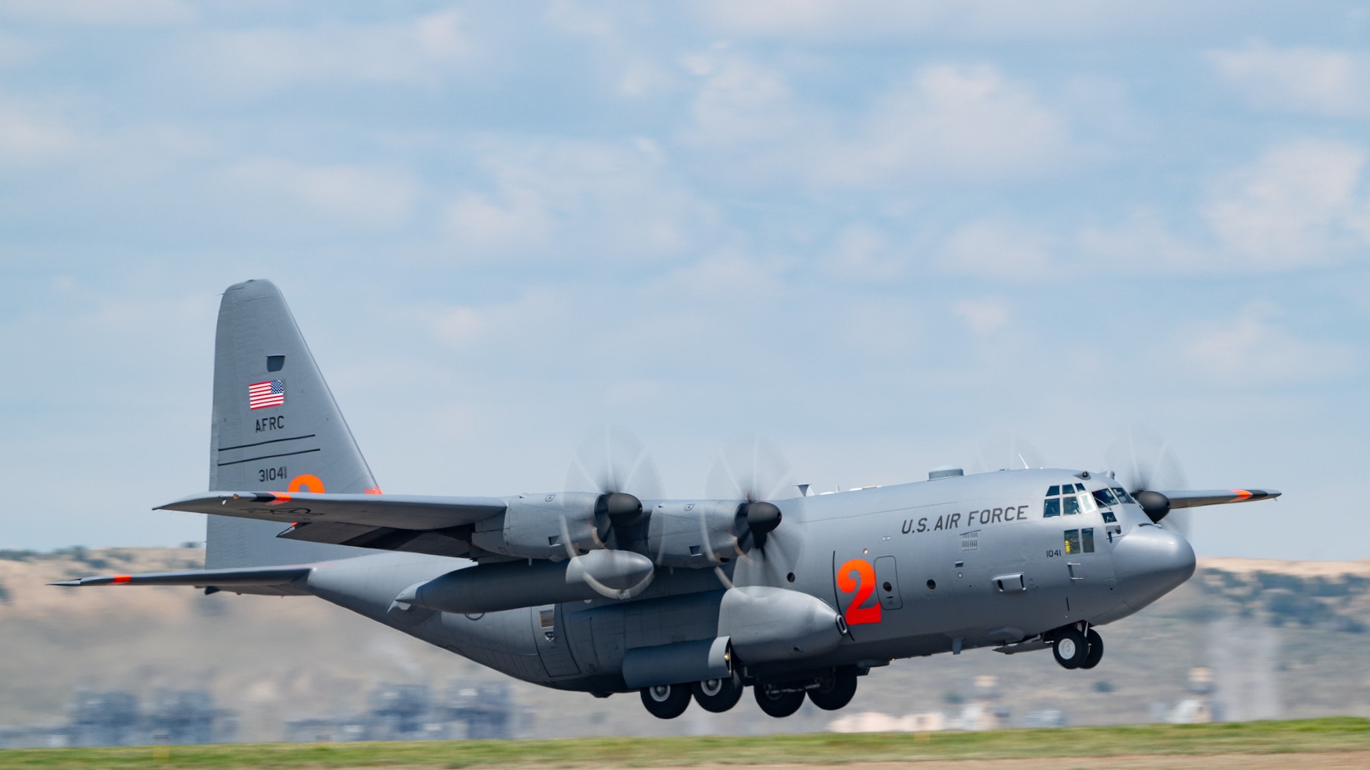 A military aircraft takes off from a runway.
