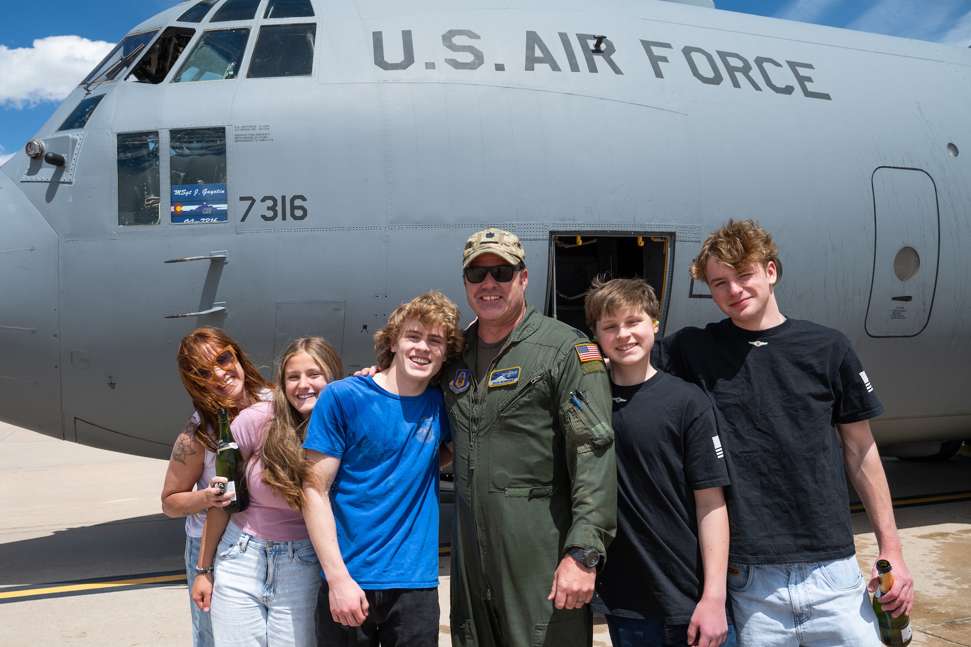 A family in front of a military aircraft.