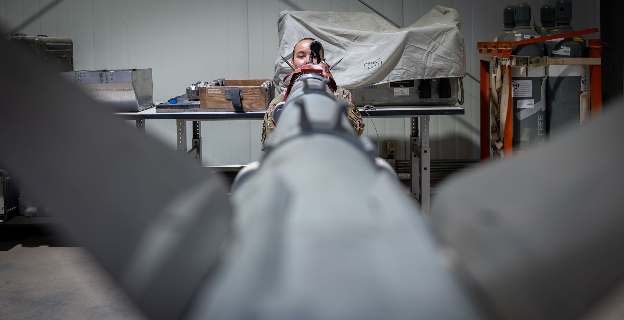 An Airman looks down an AIM-9x missile.