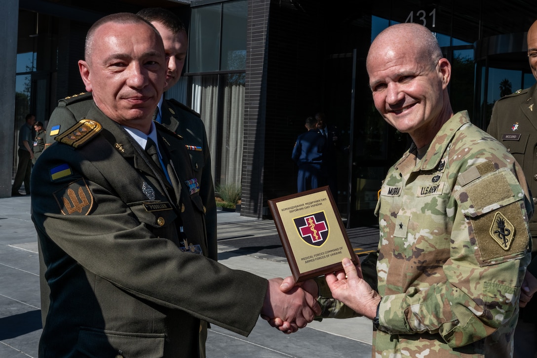 Ukrainian Col. Yurii Podolian, Medical Forces of the Armed Forces of Ukraine deputy commander, presents U.S. Army Brig Gen. Clinton Murray, U.S. Army Medical Center of Excellence commander, with a plaque showing Ukraine’s appreciation for being invited to the 2025 U.S. Central Command Medical Security Cooperation Exchange Conference, being held at the Kimpton Hotel, San Antonio Texas, May 12, 2025. Podolian also served as panelist for during the joint trauma system briefing. (U.S. Air Force photo by Joshua J. Garcia)
