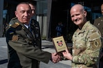 Ukrainian Col. Yurii Podolian, Medical Forces of the Armed Forces of Ukraine deputy commander, presents U.S. Army Brig Gen. Clinton Murray, U.S. Army Medical Center of Excellence commander, with a plaque showing Ukraine’s appreciation for being invited to the 2025 U.S. Central Command Medical Security Cooperation Exchange Conference, being held at the Kimpton Hotel, San Antonio Texas, May 12, 2025. Podolian also served as panelist for during the joint trauma system briefing. (U.S. Air Force photo by Joshua J. Garcia)