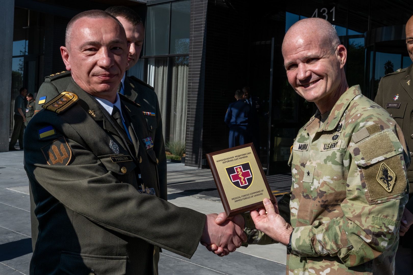 Ukrainian Col. Yurii Podolian, Medical Forces of the Armed Forces of Ukraine deputy commander, presents U.S. Army Brig Gen. Clinton Murray, U.S. Army Medical Center of Excellence commander, with a plaque showing Ukraine’s appreciation for being invited to the 2025 U.S. Central Command Medical Security Cooperation Exchange Conference, being held at the Kimpton Hotel, San Antonio Texas, May 12, 2025. Podolian also served as panelist for during the joint trauma system briefing. (U.S. Air Force photo by Joshua J. Garcia)