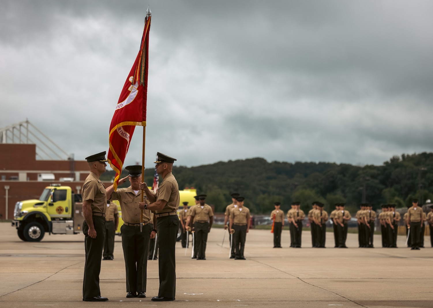 U.S. Marine Corps Lt. Col. Ethan Krumnow, left, incoming commanding officer, Marine Corps Air Facility Quantico, prepares to receive the flag from Col. Scott Warman, outgoing commanding officer, MCAF Quantico, during a change of command ceremony at MCAF on Marine Corps Base Quantico, Virginia, May 22, 2025. MCAF operates and maintains the facilities, and provides services and materiel to support the operations of Marine Helicopter Squadron 1 and other transient aircraft as required. (U.S. Marine Corps photo by Lance Cpl. Ethan Miller)