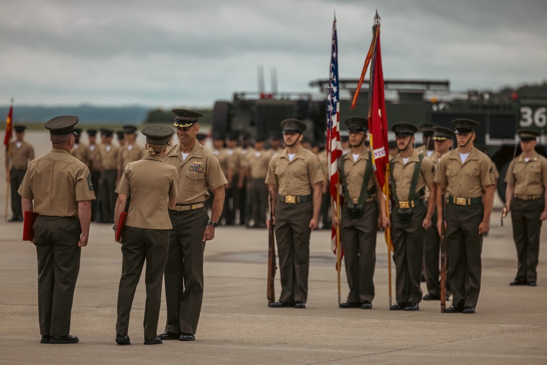 U.S. Marine Corps Col. Scott Warman, outgoing commanding officer, Marine Corps Air Facility Quantico, shakes hands with Col. Jenny Colegate, the commanding officer of Marine Corps Base Quantico, during a change of command ceremony at MCAF on MCB Quantico, Virginia, May 22, 2025. MCAF operates and maintains the facilities, and provides services and materiel to support the operations of Marine Helicopter Squadron 1 and other transient aircraft as required. (U.S. Marine Corps photo by Lance Cpl. Ethan Miller)