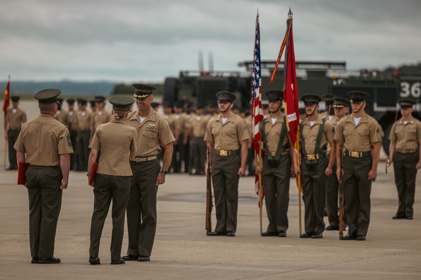 U.S. Marine Corps Col. Scott Warman, outgoing commanding officer, Marine Corps Air Facility Quantico, shakes hands with Col. Jenny Colegate, the commanding officer of Marine Corps Base Quantico, during a change of command ceremony at MCAF on MCB Quantico, Virginia, May 22, 2025. MCAF operates and maintains the facilities, and provides services and materiel to support the operations of Marine Helicopter Squadron 1 and other transient aircraft as required. (U.S. Marine Corps photo by Lance Cpl. Ethan Miller)