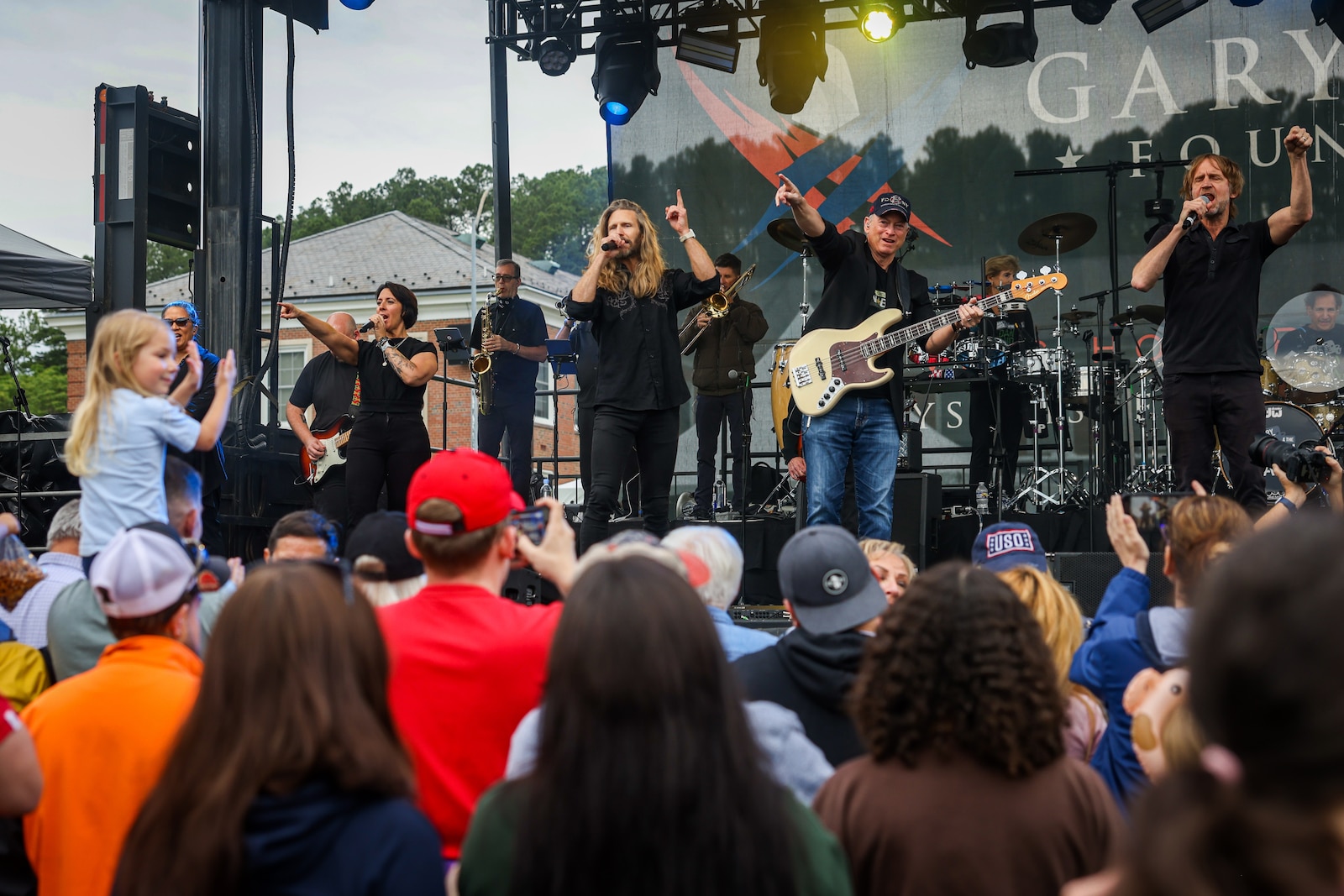 Residents of Marine Corps Base Quantico enjoy food and music at the Lt. Dan Band concert on Marine Corps Base Quantico, Virginia, May 23, 2025. The Lt. Dan Band is an American cover band, sponsored by the Gary Sinise Foundation, started by Gary Sinise and Kimo Williams to perform at United Service Organization shows, entertain troops, and raise money for disabled veterans. (U.S. Marine Corps photo by Lance Cpl. Jeffery Stevens)