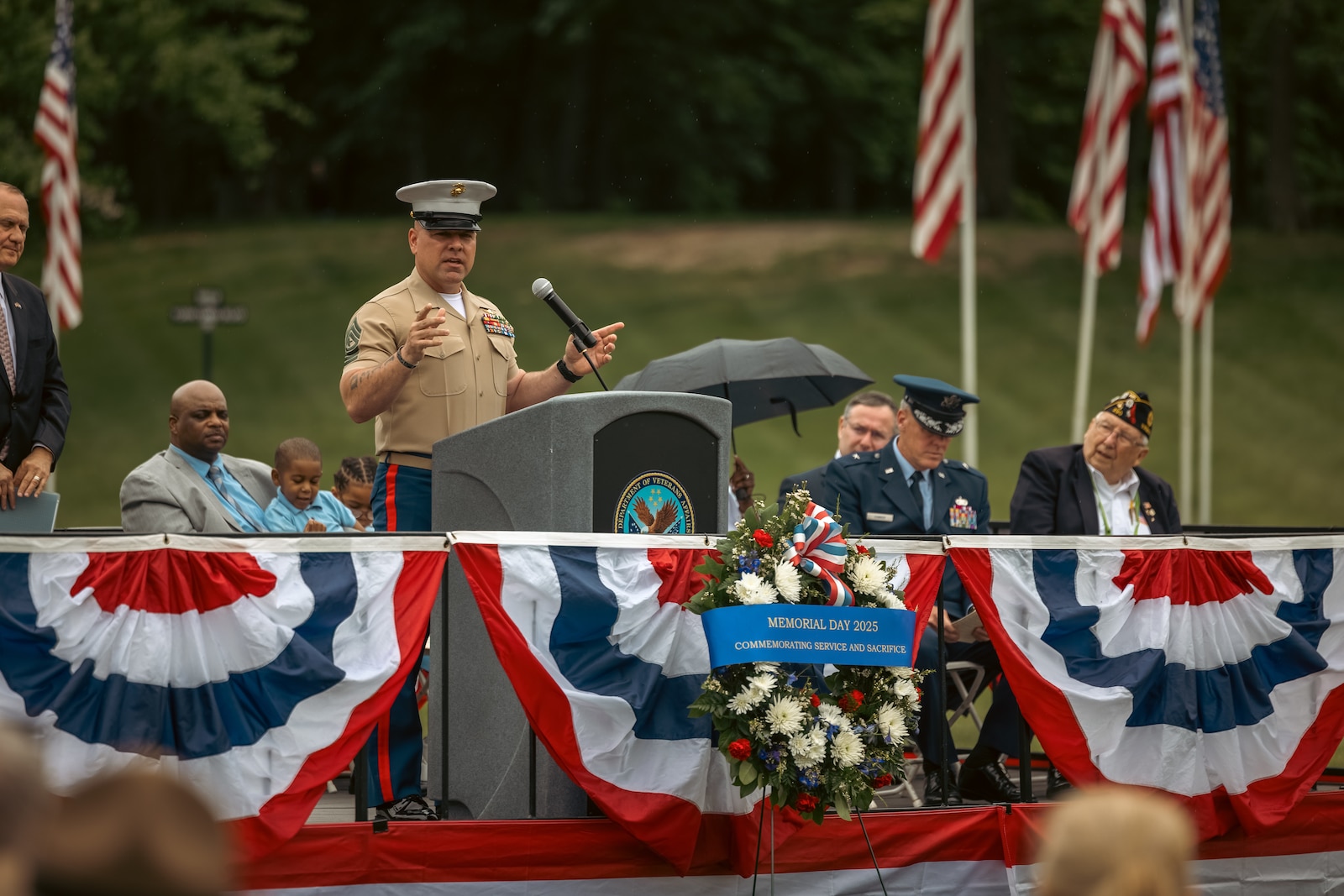 U.S. Marine Corps Sgt. Maj. Michael Brown, sergeant major of Marine Corps Base Quantico, addresses the crowd during a Memorial Day ceremony at the National Memorial Cemetery at Quantico, Triangle, Virginia, May 26, 2025. The ceremony is held annually on Memorial Day weekend to honor the memory and military service of the service members buried there. (U.S. Marine Corps photo by Lance Cpl. Ethan Miller)