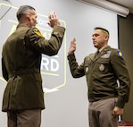 Lt. Col. Lance Frail, Commander, Recruiting and Retention Battalion, administers the oath of office to newly commissioned 2nd Lt. Thomas Luca II during a commissioning ceremony May 17 at the Illinois Military Academy, Camp Lincoln, Springfield.