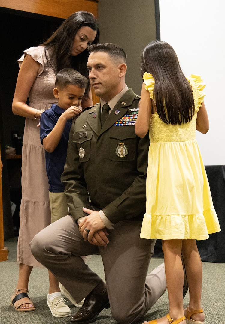 Jolene, Audriana and Thomas Luca III, the wife and children of newly commissioned 2nd Lt. Thomas Luca II, pin on his new rank during a commissioning ceremony May 17 at the Illinois Military Academy, Camp Lincoln, in Springfield. Luca graduated from the Illinois Army National Guard Officer Candidate School in August and commissioned into the Adjutant General Corps.