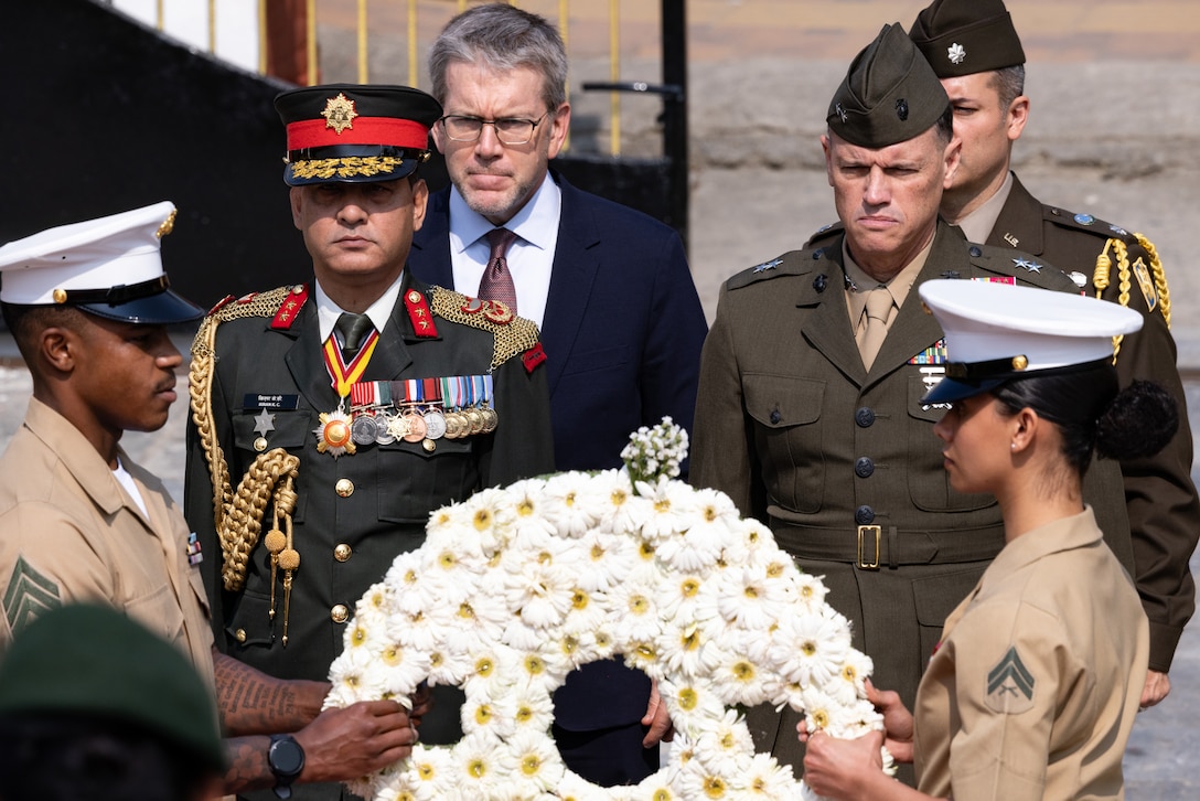 U.S. and Nepali service members, and distinguished guests carry a Gerbera Daisy flower wreath to the Eternal Flame Memorial during the 10th Anniversary Operation Sahayogi Haat Wreath Laying Ceremony at the Nepal Military Museum, Kathmandu, Nepal, May 12, 2025. On May 12, 2015, a UH-1Y Huey helicopter, Vengeance 01, crashed while attempting to rescue wounded civilians, resulting in the deaths of all eight individuals on board, including U.S. Marines and Nepalese soldiers.
