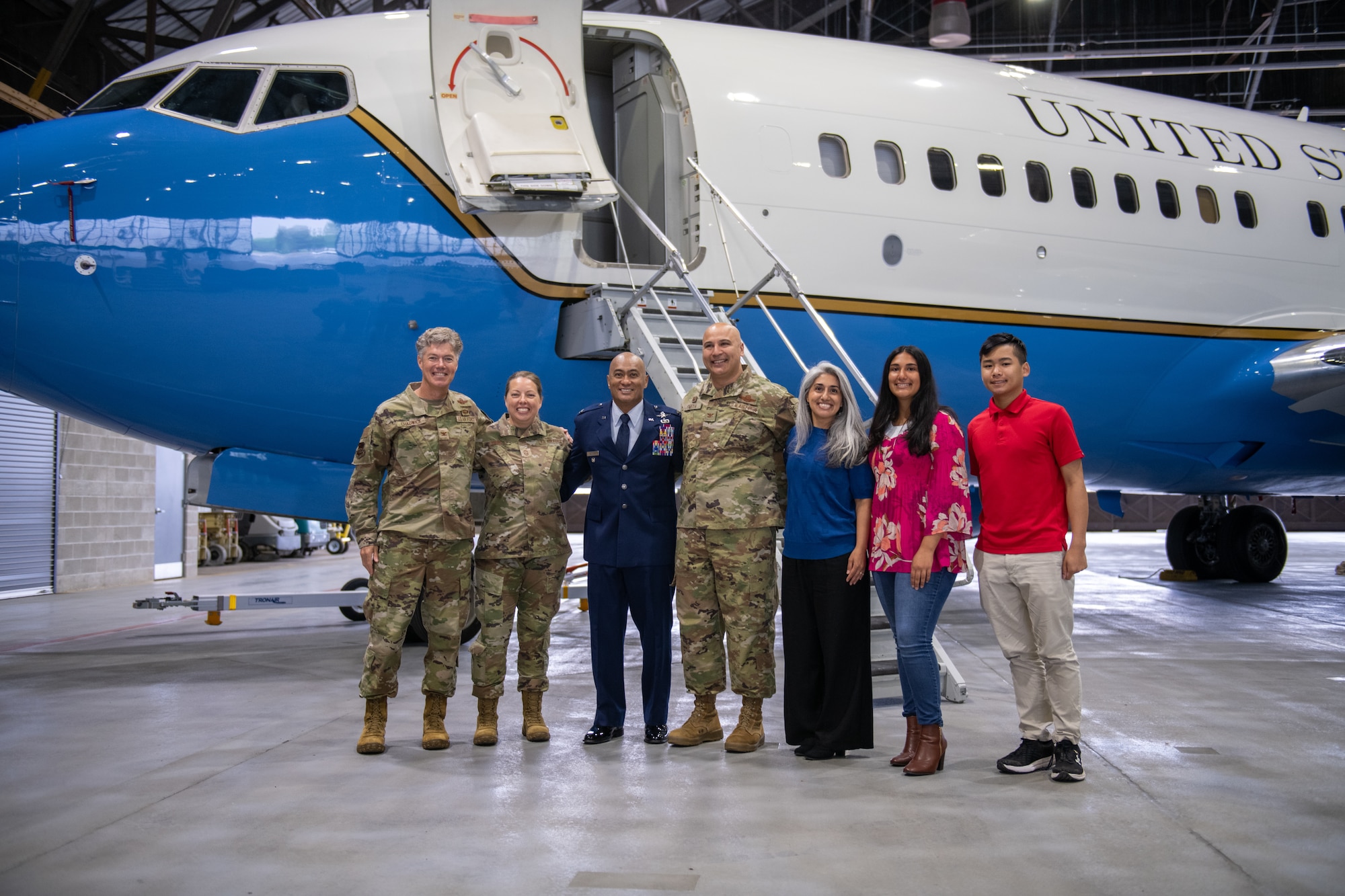 Col. Melchizedek Martinez (second from left) poses for a photo in front of a 932nd AW C-40C aircraft next to Col. Jeffrey Smith, 932nd AW commander (center) and Smith's family, Col. Rick Chadwick, 932nd AW deputy commander (left), and Chief Master Sgt. Andrea Young, 932nd AW command chief (second from left), after concluding his speech on resiliency to Gateway Wing Airmen during the 932nd AW Resilience Quest event May 3, 2025, Scott Air Force Base, Illinois.