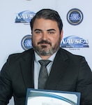 Evan Sarantos, Naval Surface Warfare Center Panama City Division’s Expeditionary Sea Base Command, Control, Communications, Computers, and Intelligence Project lead systems engineer, receives the NSWC PCD FY24 Annual Award for Technical Excellence, March 27. This mission is essential to supporting the Force Behind the Fleet as a crucial element for effective modern warfare in complex and dynamic environments. (U.S. Navy photo by Eddie Green)