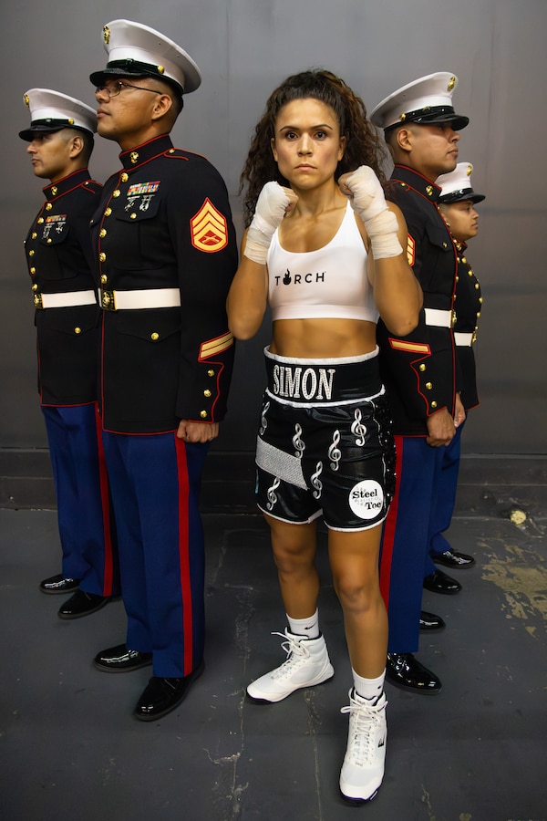 U.S. Marine Corps Capt. Stephanie Simon, center, a member of the U.S. Marine Corps Boxing Team, poses for a photograph with Marines during her professional boxing debut photoshoot at Forj Boxing Club and High-Performance Center in Los Angeles, Sept. 20, 2024. Simon’s debut boxing match is scheduled for Sept. 27, 2024, in Atlanta. (U.S. Marine Corps photo by Cpl. Bruin Largent)