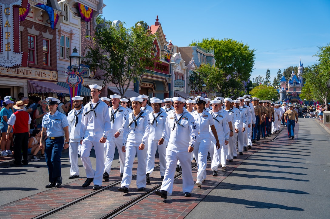 U.S. Navy Sailors and Marines parade through Disneyland Park in Anaheim, California, during Los Angeles Fleet Week, May 22, 2025. Los Angeles Fleet Week, now in its eighth iteration, is a sea service celebration that allows citizens of Greater Los Angeles to witness today’s maritime capabilities firsthand. Nearly 1,000 Sailors, Marines, and Coast Guardsmen will showcase their capabilities and equipment, participate in various community service events, and enjoy the hospitality of Los Angeles during the event. (U.S. Marine Corps photo by Lance Cpl. Avery Wayland)