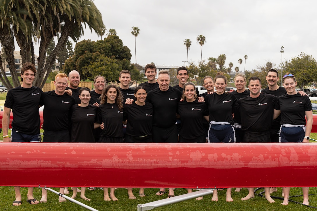 U.S. Marines and members of U.S. Rowing pose for a photograph after an exhibition race during the San Diego Crew Classic at Crown Point Beach in San Diego, California, March 28, 2025. The San Diego Crew Classic brings junior, collegiate, masters, elite, and para competitors together across a weekend of races at Crown Point Shores. (U.S. Marine Corps photo by Cpl. Bruin Largent)